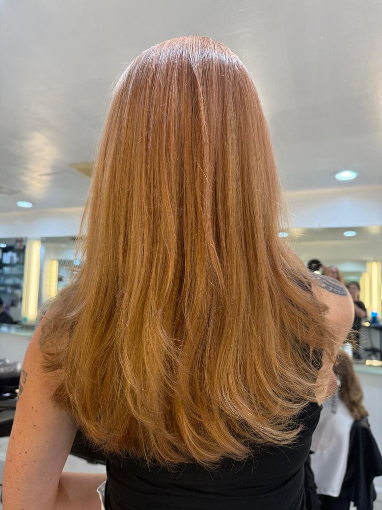 woman in hair salon getting her hair styled