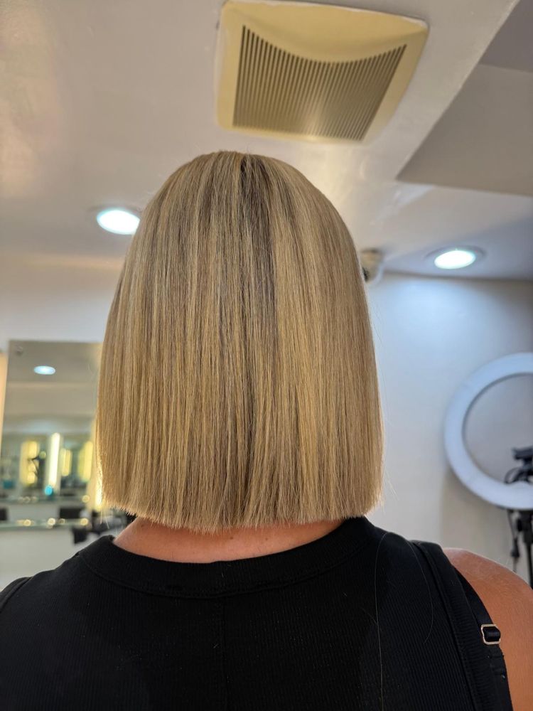 woman in hair salon getting her hair styled