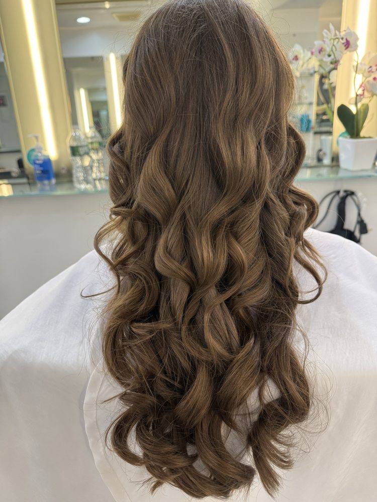 woman's hair styled with curling iron