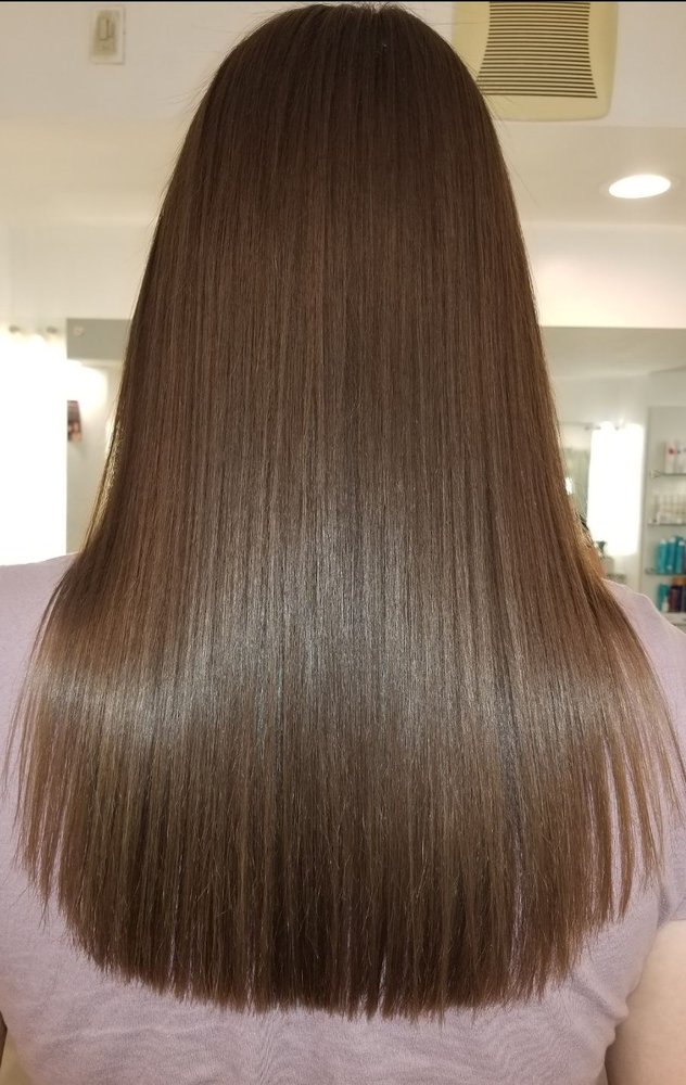 woman in hair salon getting her hair styled